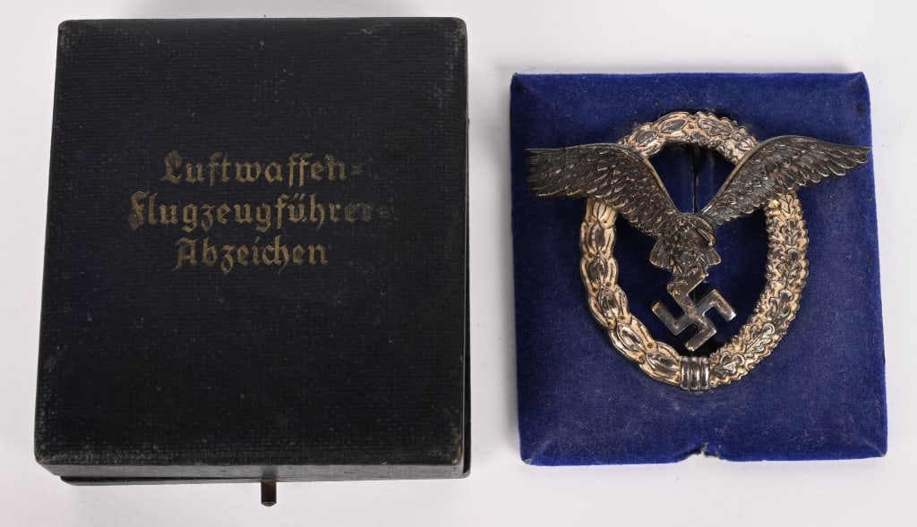 WWII NAZI GERMAN LUFTWAFFE EARLY PILOT BADGE B&NL: Nice quality, early die struck Tombac alloy construction, two piece badge is in the form of a vertically oval wreath with a separate burnished silver finished, stylized, spread winged eagle in flight,