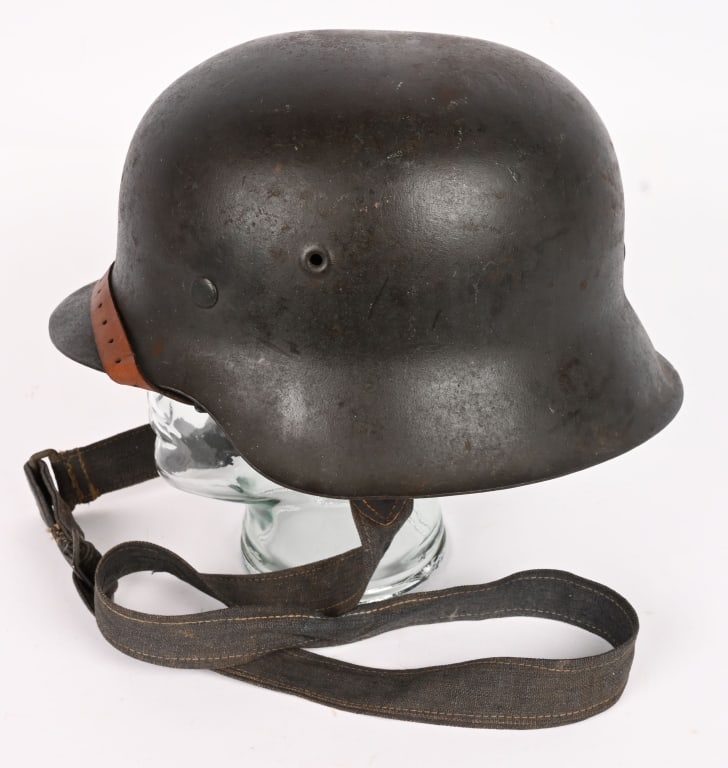WWII NAZI GERMAN M42 COMBAT HELMET 66 W LINER WW2: This stamped sheet steel construction helmet retains about 95% of its original field-gray paint. All three liner retaining rivets are intact. The interior of the helmet has a M31 liner in place. Leath
