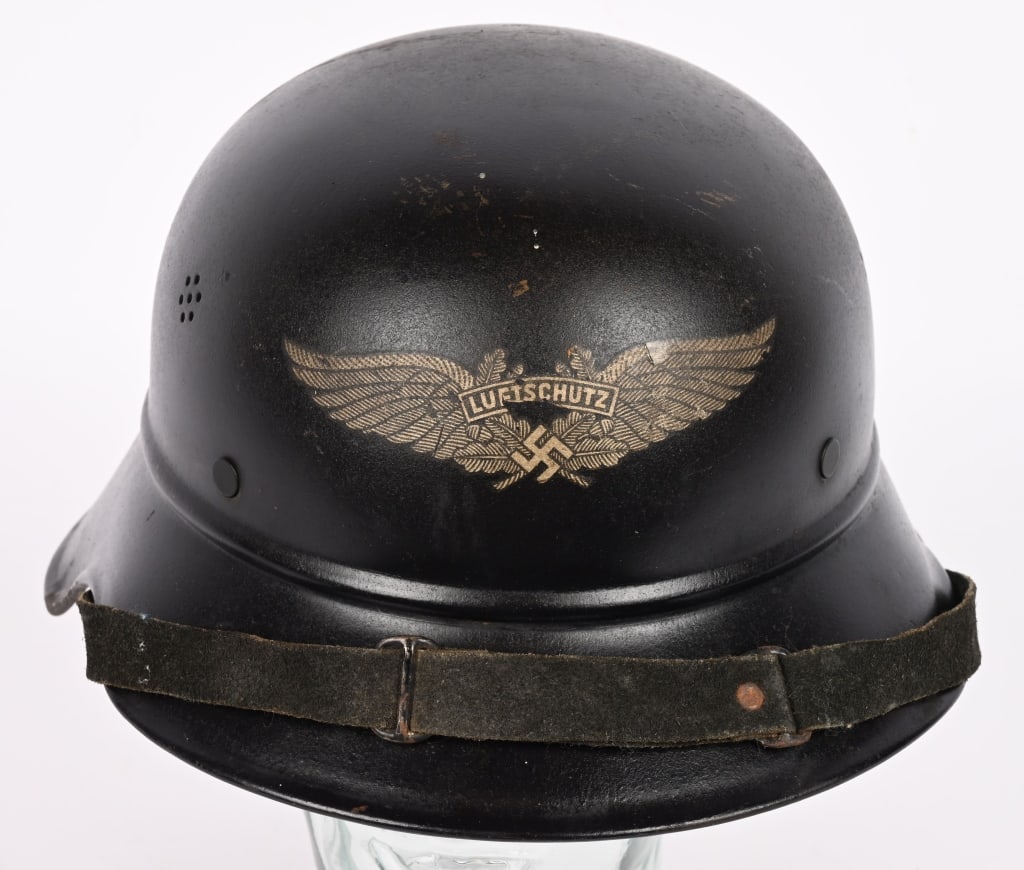 WWII NAZI LUFTSCHUTZ BEADED M38 GLADIATOR HELMET: The three piece, stamped, sheet steel construction Luftschutz M38 "Gladiator" style helmet retains most of its original, smooth, dark satin blue paint. The front center of the helmet has a Luftschutz 