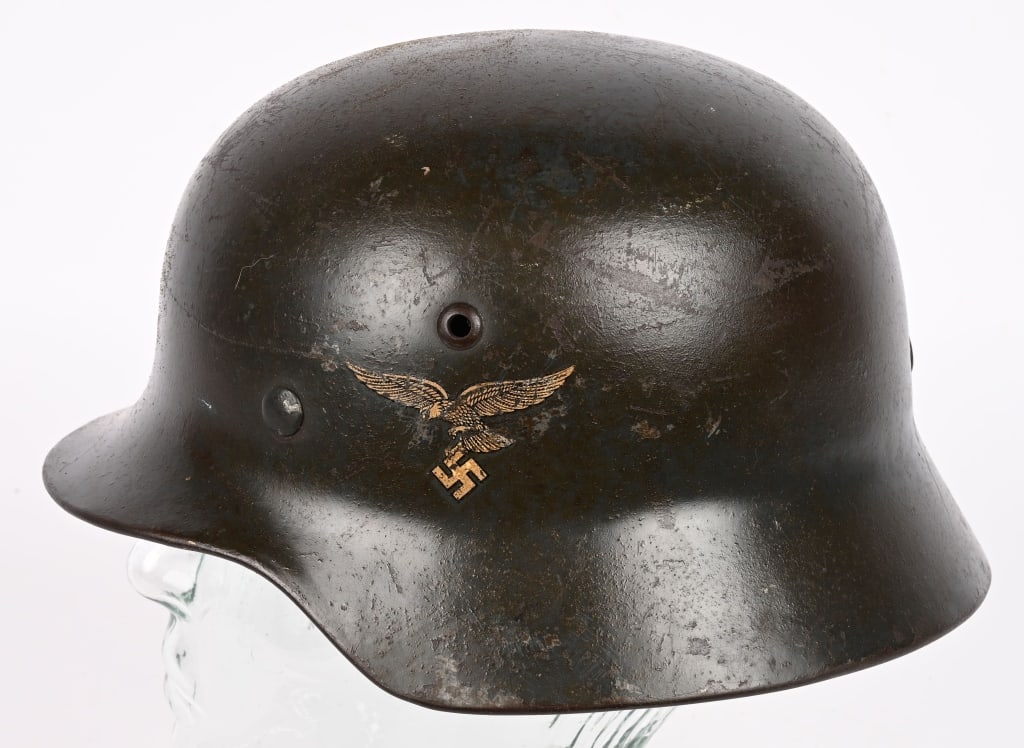 WWII NAZI GERMAN LUFTWAFFE M35 DD UNIT MKED HELMET: The stamped, sheet steel construction helmet retains most of its original paint. The left side of the helmet has a first pattern black detailed, silvery/white, Luftwaffe eagle decal, clutching a cante