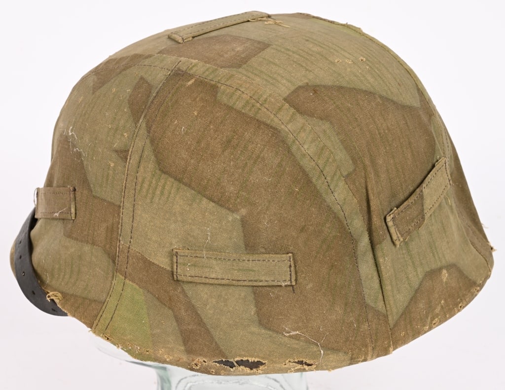 WWII NAZI GERMAN HEER M40 SD HELMET W CAMO COVER: The stamped, sheet steel construction helmet retains most of its green painted finish. The left side of the helmet has an Wehrmacht eagle shield decal featuring a eagle with down-swept wings, clutchin