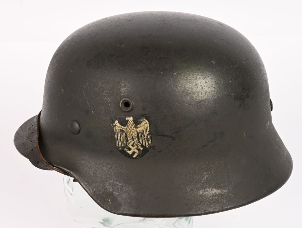 WWII NAZI GERMAN HEER M40 SD HELMET W LINER ET66: The stamped, sheet steel construction helmet retains most of its green painted rough finish. The left side of the helmet has an Wehrmacht eagle shield decal featuring a eagle with down-swept wings, cl