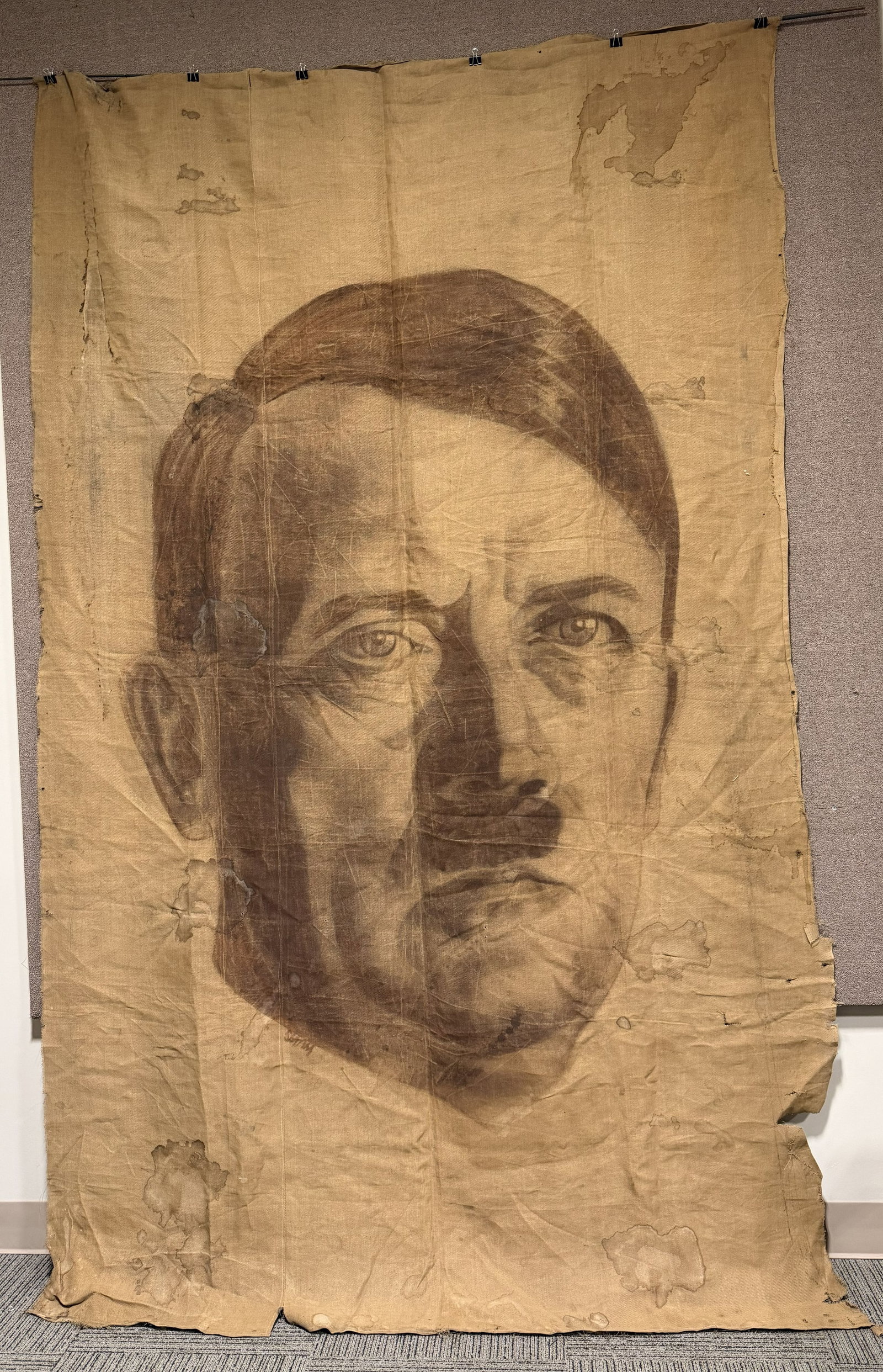 WWII NAZI GERMAN PAINTING OF ADOLF HITLER SIGNED: WWII Nazi German 12 feet X 74 inches burlap painting of Adolf Hitler that is artist signed. The image is expertly hand painted with a great amount of skill. The burlap material shows wear to the edges