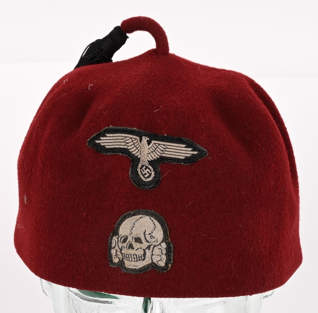 WWII NAZI GERMAN MAROON SS FEZ SIZE 56 WW2: Nice quality, formed, maroon, rabbit fur felt, construction dress uniform fez. The fez features a two piece tassel to the top center of the crown. The tassel has a short piece of maroon felt inserted 
