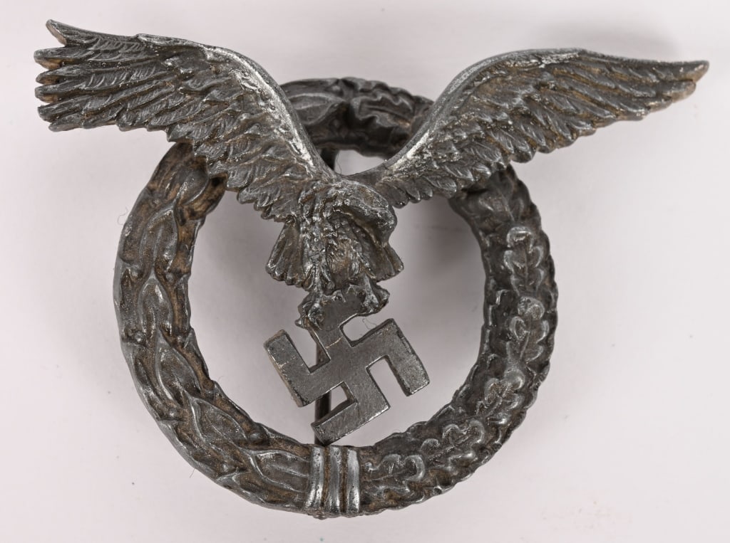 WWII NAZI GERMAN LUFTWAFFE ROUND PILOT BADGE WW2: (Flugzeugführerabzeichen, runder Type). A rare example of a circular wreath Pilot's Badge, constructed of silvered zink, the obverse consisting of a circular laurel and oak leaf wreath, joined to