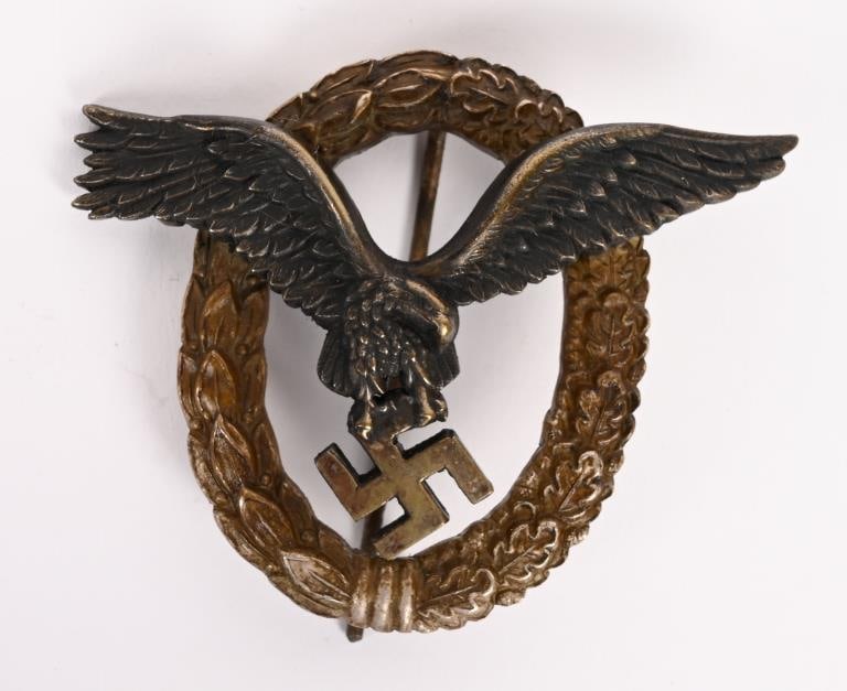 WWII NAZI GERMAN LUFTWAFFE PILOT BADGE BY JUNCKER: Luftwaffe Pilot Badge Pilotenabzeichen; two-piece construction - badge in silvered tombac with a silvered wreath and patinated eagle; vertical pinback; marked “C.E Junker, Berlin SW” on re