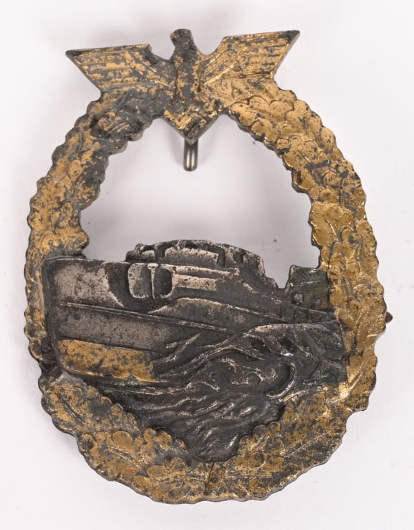 WWII NAZI GERMAN KRIEGSMARINE S BOAT WAR BADGE WW2: Die struck, French made, zinc alloy, first pattern S-boat badge. The badge is in the form of a vertically oval, oak-leaf wreath with a small national eagle with out-stretched wings superimposed to the