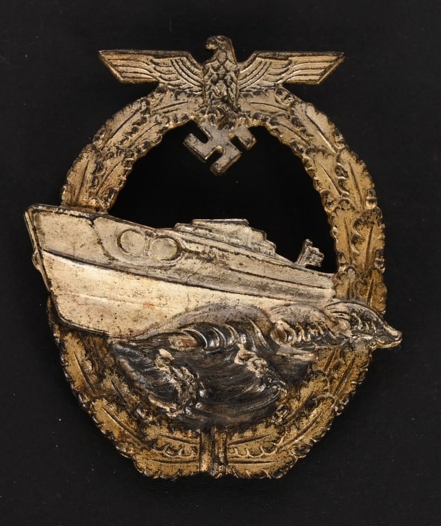 WWII KRIEGSMARINE SCHNELLBOOT E BOAT BADGE WW2: Die struck second pattern S-boat badge. The badge is in the form of a vertically oval oak-leaf wreath with a small national eagle with out-stretched wings superimposed to the top center encompassing a