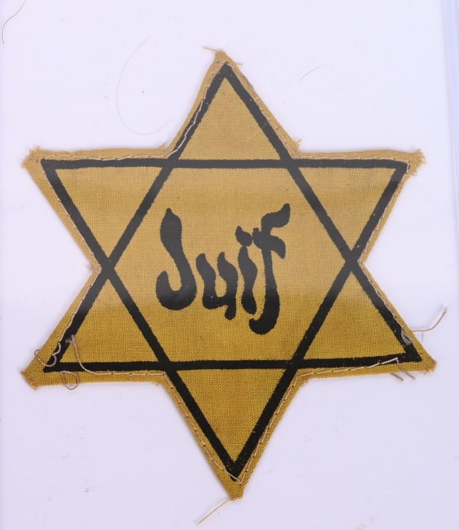 WWII NAZI GERMAN JEWISH GHETTO FRENCH STAR WW2: WWII Nazi German Jewish Ghetto French Clothing Star. Measures 3 13/16" wide by 4 7/16" tall. The front reads "Juif" in French in the center of the six armed yellow Star of David. It has been removed f