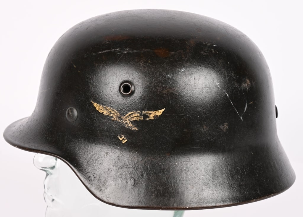WWII NAZI GERMAN M40 LUFTWAFFE SINGLE DECAL HELMET: The stamped sheet steel construction helmet retains 80% of its original rough textured paint. The left side of the helmet has a second pattern (Circa 1936/1937-1945) black detailed silvery/white Luftw