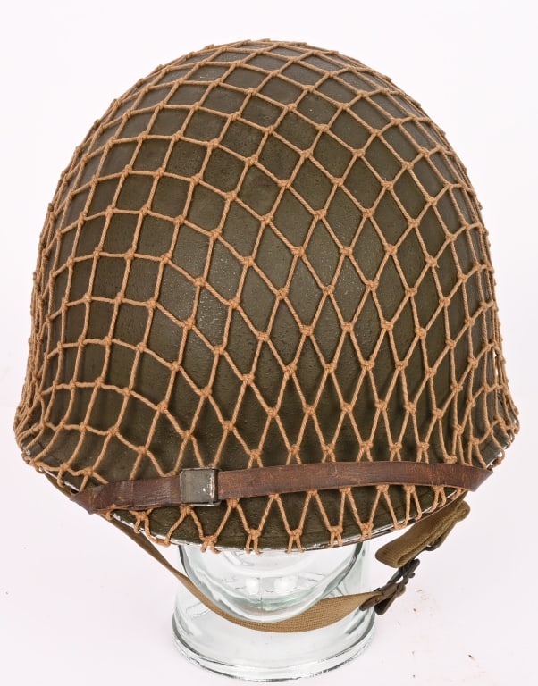 WWII US M1 FIXED BAIL COMBAT HELMET WITH LINER WW2: An absolutely MINT, WWII US Army Fixed bale front seam magnesium shell helmet. The shell retains all of its rough-textured olive drab paint to the exterior. Chinstrap is complete. Liner is complete