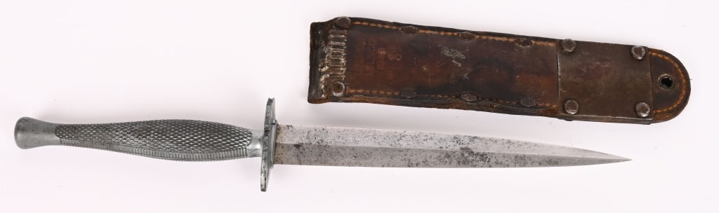WWII MARINE RAIDER FIGHTING KNIFE BY CAMILLUS WW2: WWII U.S. MARINE CORPS RAIDER STILETTO FIGHTING KNIFE WITH CUT M^ SCABBARD. Circa 1942 U.S. Marine Corps Raider issued Stiletto Fighting Knife. This is a textbook example of one of these very rare