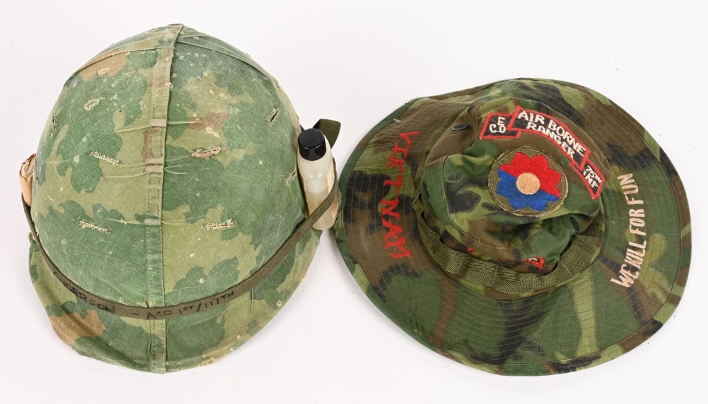 VIETNAM CAMO BOONIE HAT & COMBAT HELMET W COVER: Lot of two, Vietnam Pieces of Headgear to include 1) CAMO BOONIE CAP. Cap is direct embroidered to the brim Vietnam & WE KILL FOR FUN. to the top of the cap is patched AIRBORNE RANGER Co. E 75th INF.