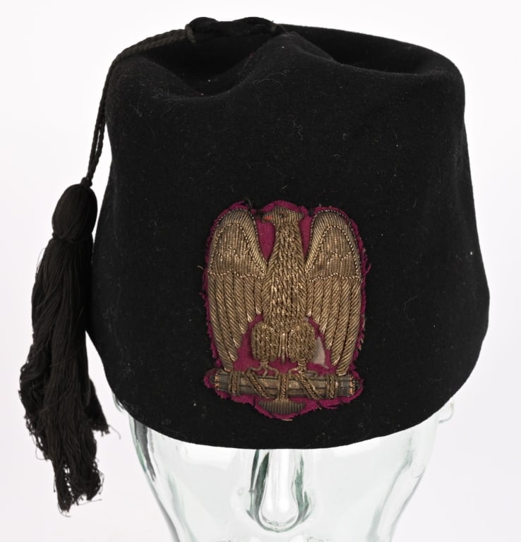 WWII FASCIST LEADERS ITALIAN FEZ BULLION INSIGNIA: A very nice quality, black felt fez with a large, black tassel fixed by a dual black cord to its crown. To its unlined interior and to the exterior a beautiful toned Political Officers bull
