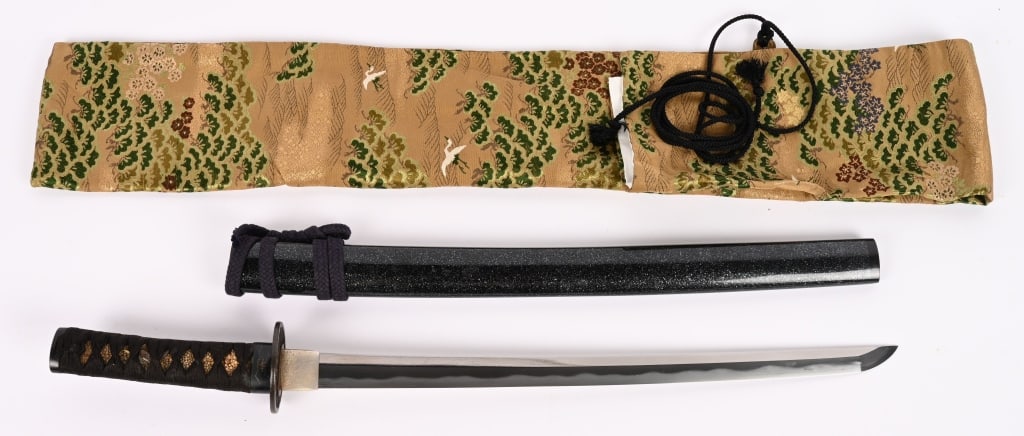 WAKIZASHI SWORD W SAYA & SUKASHI TSUBA EDO PERIOD: Antique Black Wakizashi Sword, Sukashi Tsuba Early Edo Period with a cutting edge of 17 1/2 inches and is high polish. Comes with the silk storage bag. Excellent.