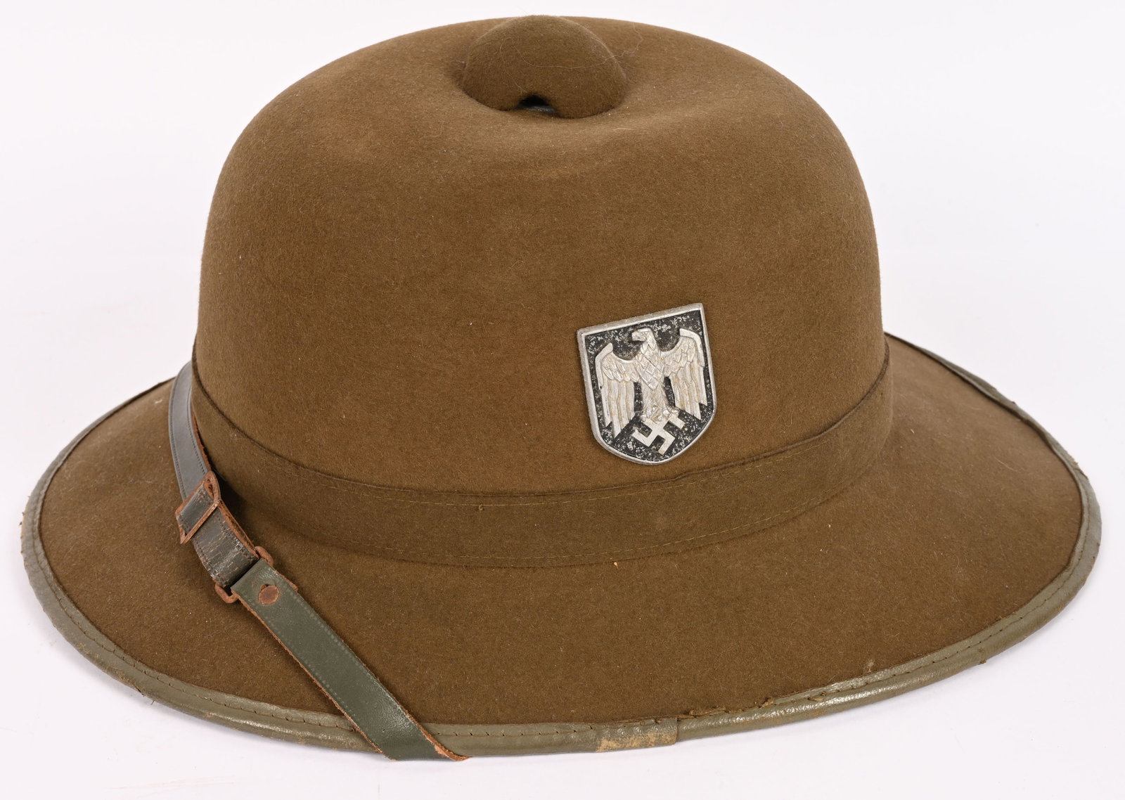 WWII NAZI GERMAN TROPICAL PITH HELMET 1941 DATED: Second pattern pith helmet constructed in a one piece seamless formed olive-drab felt crown with a horizontal band stitched at the rear center and covered by a vertical strip of felt mounted on a form