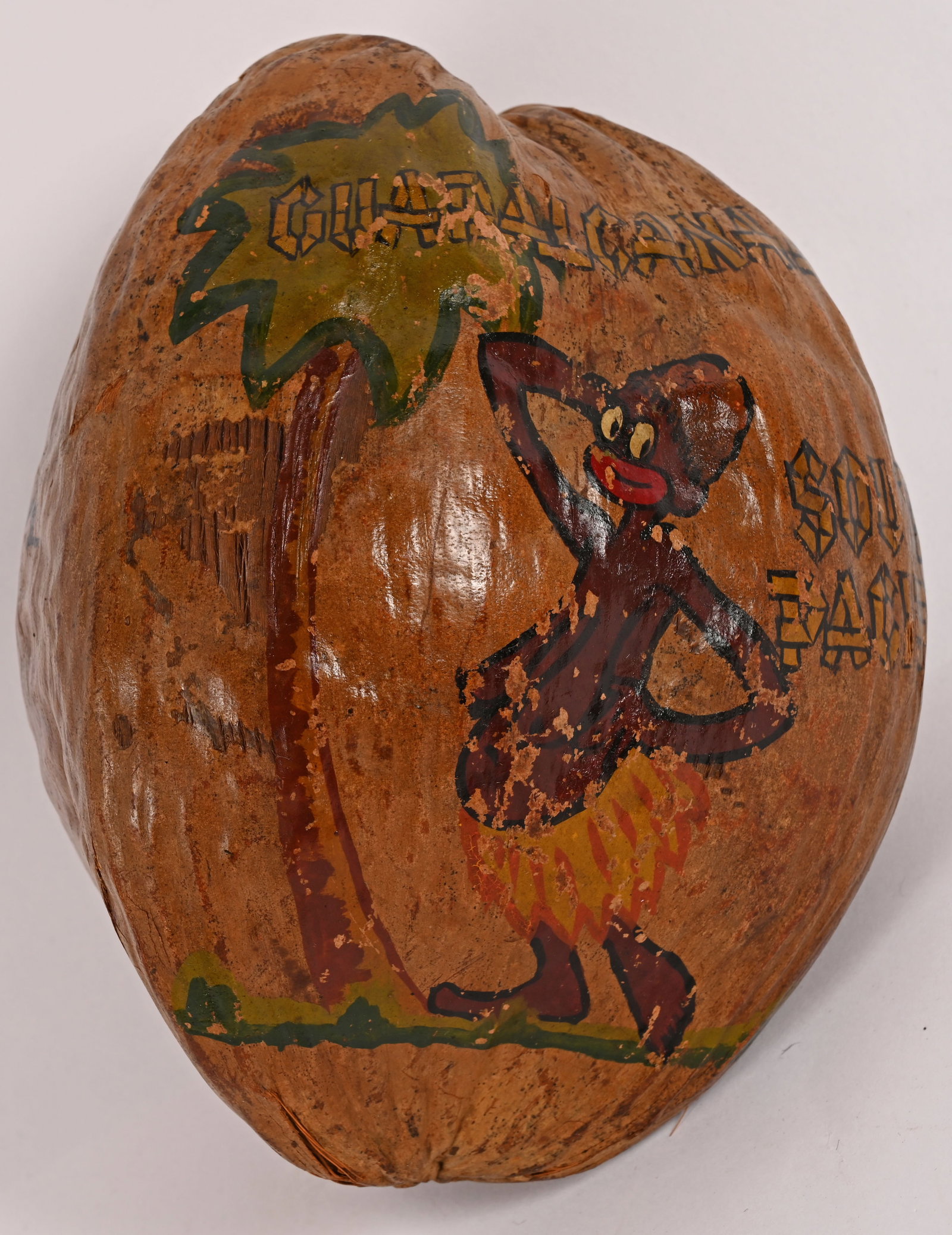 WWII US GI PAINTED COCONUT FROM GUADALCANAL WW2: WWII Souvenir Coconut from the Island of Guadalcanal in the South Pacific in 1944 and was hand painted with an islander with a palm tree and to the reverse Merry Xmas 1944 and measures roughly 8 inche