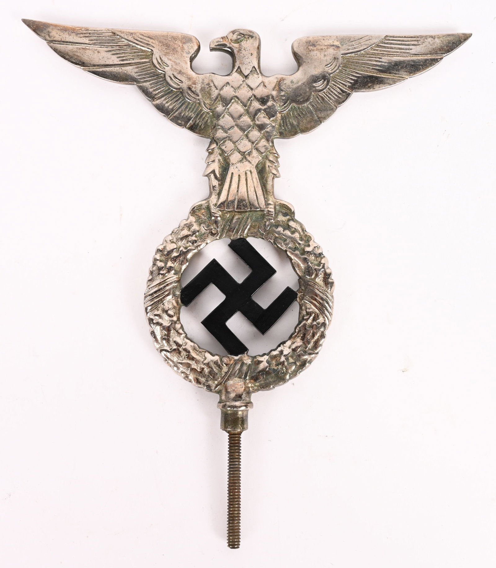 WWII NAZI GERMAN EARLY NSDAP POLE TOP WW2: EARLY NSDAP POLITICAL FLAG POLE FINIAL. A nickel silver flag pole finial, in the form of an eagle whose outstretched wings have a span of 8 inches and which clutches a wreathed, mobile swastika in its