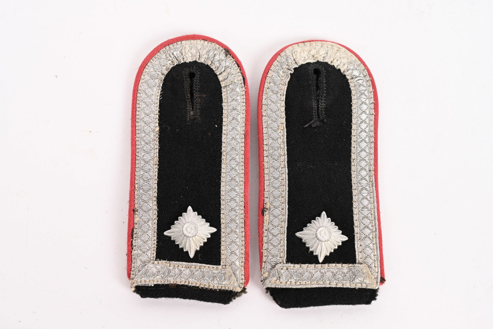 WWII SS OBERSCHARFÜHRER PANZER SHOULDER BOARDS: Black wool construction slip on shoulder straps with bright diamond patterned NCO's tress and pink rayon waffenfarbe piping. The bottoms of the straps are in field-gray wool while the narrow slip on r
