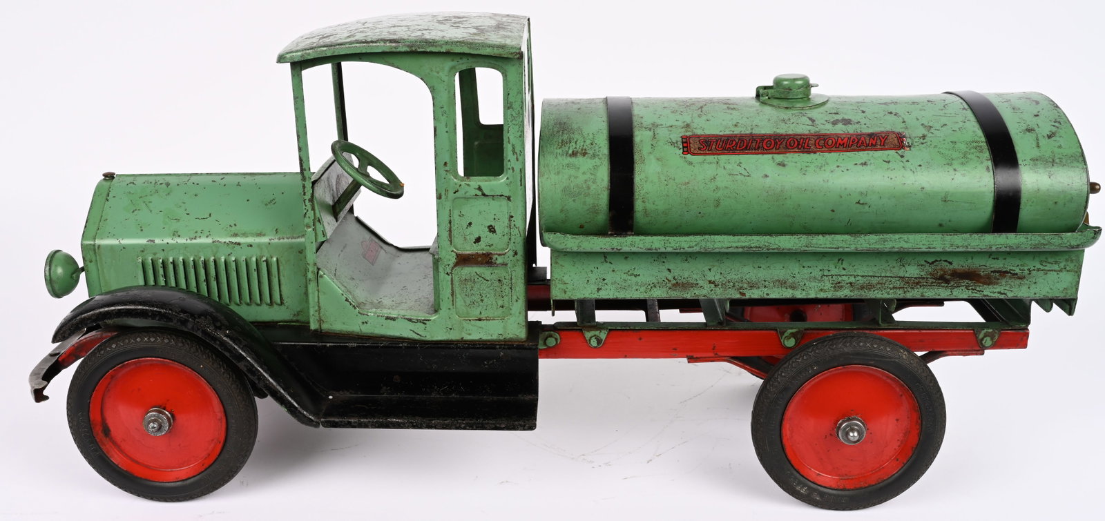 STURDITOY OIL COMPANY TANK TRUCK: Sturditoy pressed steel Oil Company Tank Truck. Very rare teal green color. With decent paint that shows some normal wear. Decals have been replaced. Some minor touchup. Still displays well. 27" Very