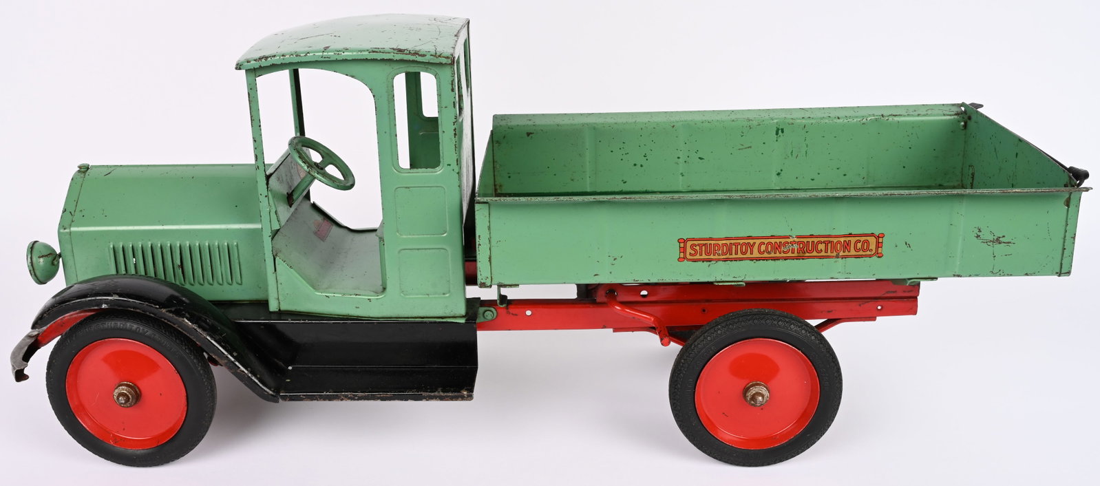 STURDITOY CONSTRUCTION COMPANY DUMP TRUCK: Sturditoy pressed steel Construction Company Dump Truck. Scarce teal green color. All original with very nice paint and decals. A hard truck to find in this color combo. 28" Excellent