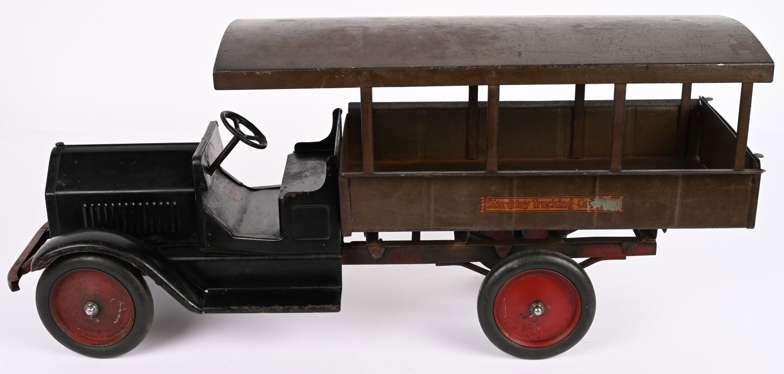STURDITOY TRUCKING COMPANY HUCKSTER: Sturditoy pressed steel Trucking Company Huckster. A very rare truck. All original paint and decals. Has some normal wear. Rear axle repaired and repainted. Hard to find truck in any condition. 27"