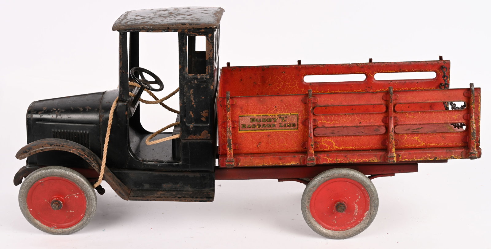 BUDDY L BAGGAGE TRUCK: Buddy L pressed steel Baggage Truck. Period repaint with lots of character. Bed has been painted unusual red color. Said to possibly be a paint sample from the factory. Original yellow can be seen