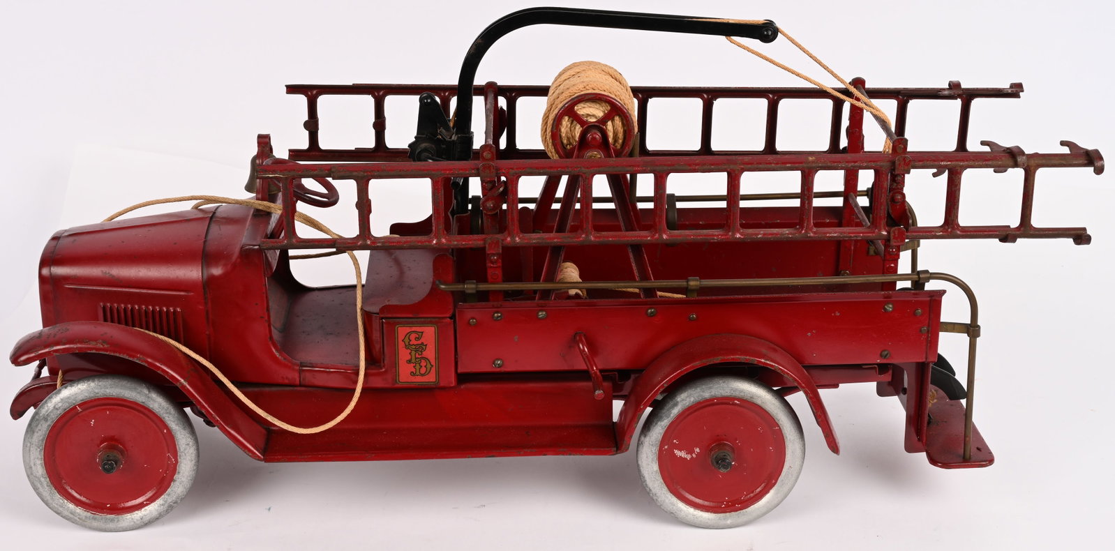 BUDDY L HOOK & LADDER FIRE TRUCK: Buddy L pressed steel Hook & Ladder Fire Truck. Early dark red version. All original with nice paint and decals. Still has all its original accessories. Still has original pull cord. Hard to find in