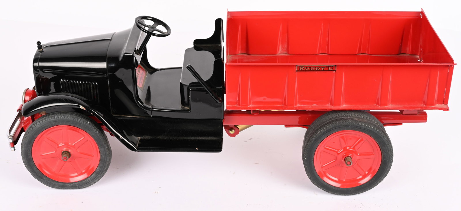 BUDDY L RUBBER TIRE DUMP TRUCK: Professionally restored Buddy L Rubber Tire Dump Truck. Restored in the scarce Black and Red colors. One fender has a very minor bend and paint chip. Very well done restoration and displays great.