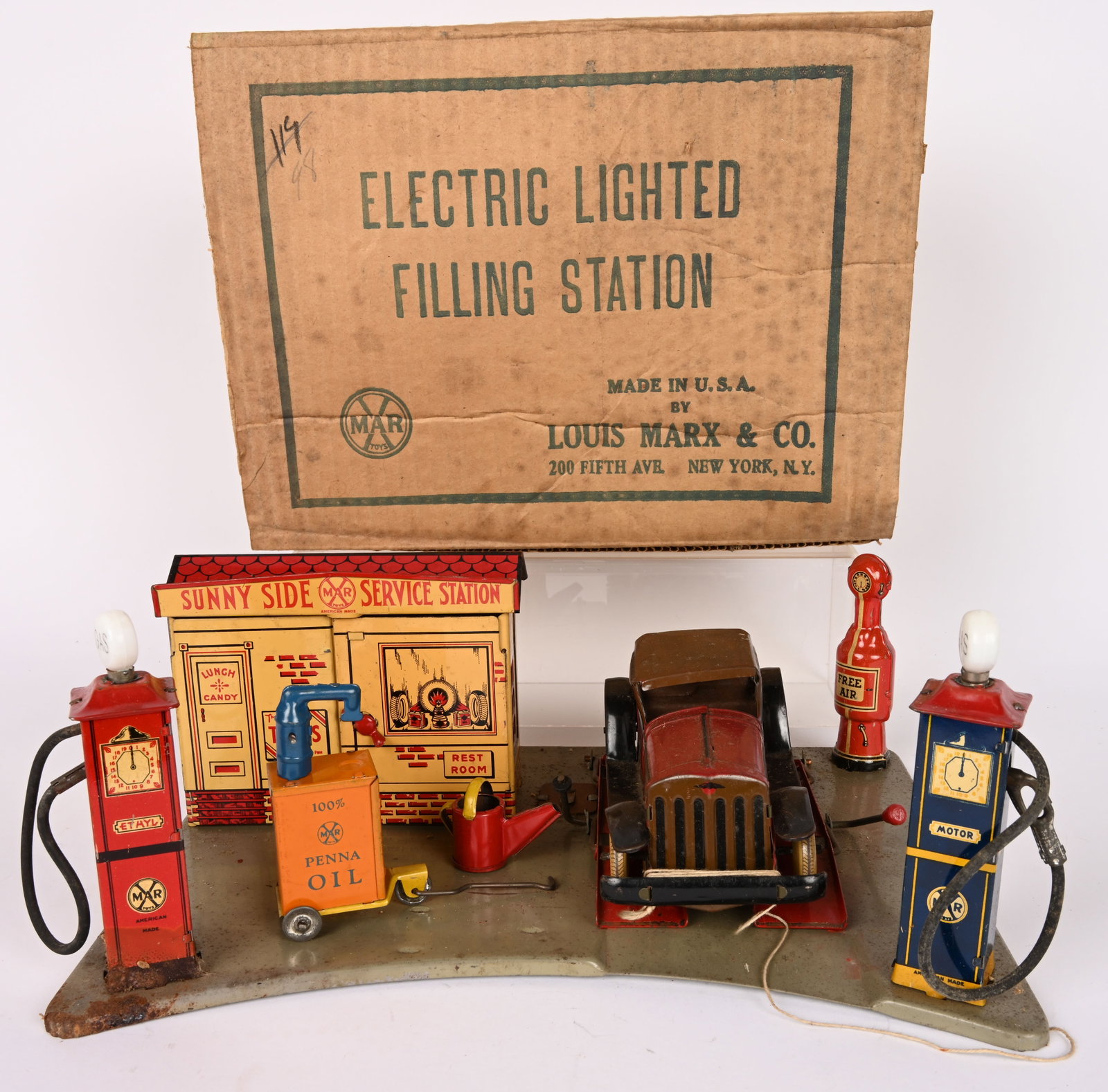MARX ELECTRIC LIGHTED STATION w/ BOX: Marx Electric Lighted Station. All original and complete with tin windup Car, Oil Pump, and Water Can. All in decent condition. Comes with Box. 14" Very Good-Excellent