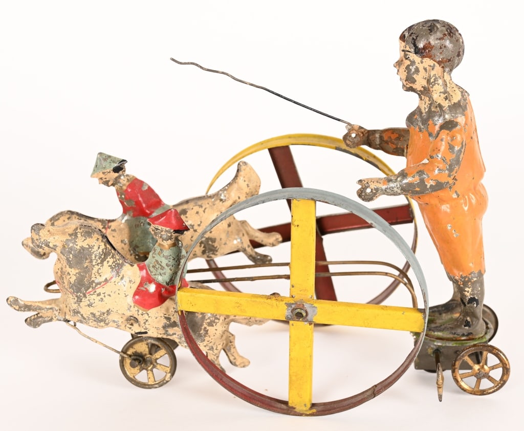 GERMAN HAND PAINTED TIN WINDUP DOGS PULLING BOY: German hand painted tin windup Dogs Pulling Boy. Large and impressive toy. Great design with 2 Dogs with Child Riders pulling Standing Boy. All original condition. Windup works. 10" Very