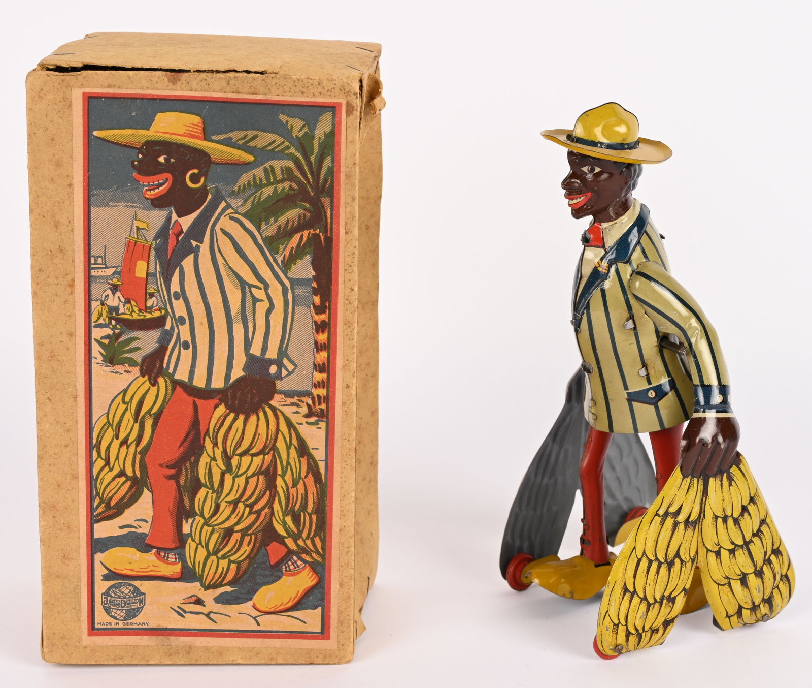 DISTLER TIN WINDUP BANANA MAN w/ BOX: German tin windup Banana Man. All original with wonderful colors. Very clean example. Windup works. With scarce Box. 7" Excellent