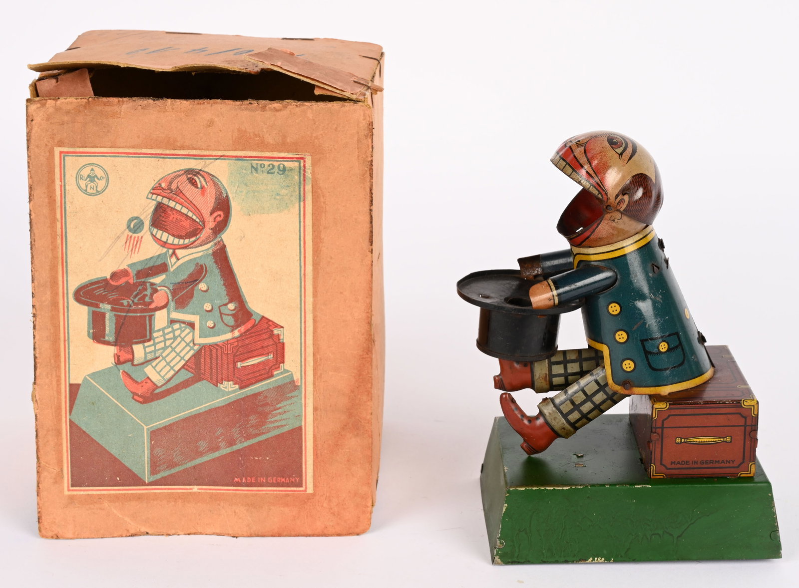 GERMAN TIN WINDUP EATING MAN w/ BOX: German tin windup Eating Man. All original and in great condition. Has very nice colors. Windup works. Comes with wooden balls for food. Comes with scarce Box. 7" Excellent