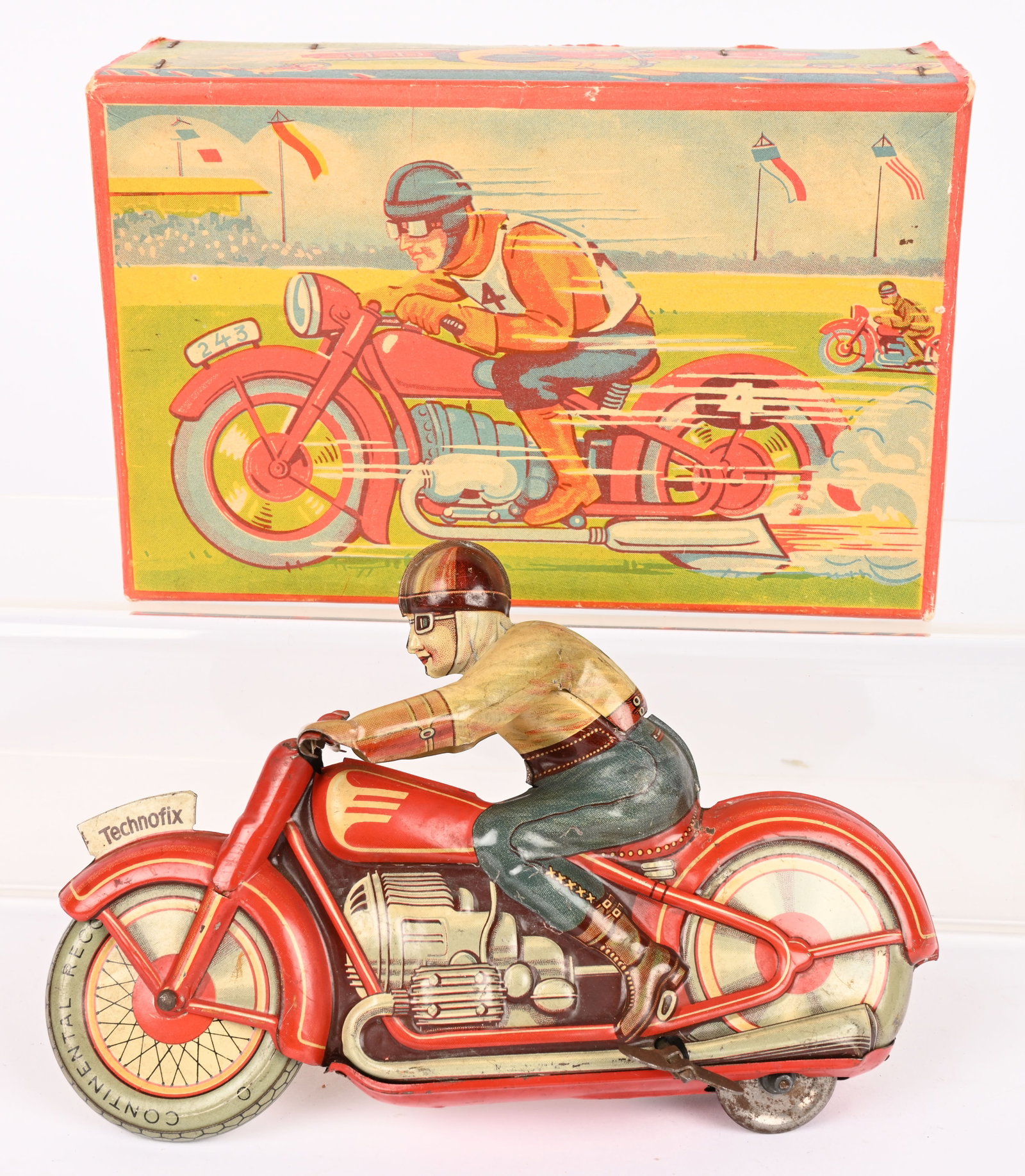 US ZONE TECHNOFIX TIN WINDUP MOTORCYCLE w/ BOX: US Zone Germany tin windup Racing Motorcycle. Complete and original. Windup worked when tested. Original box has great graphics. 7 1/2" Excellent