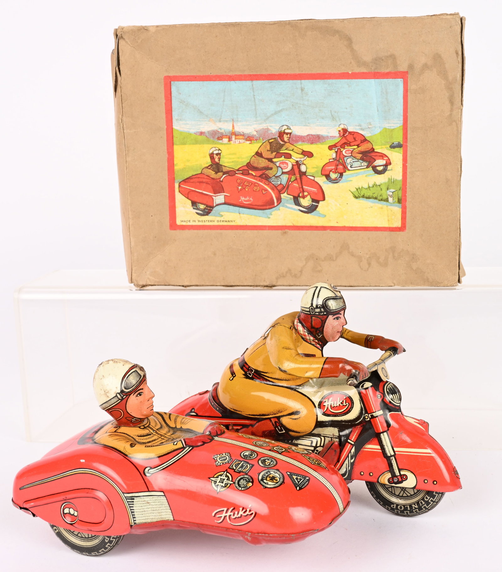 HUKI TIN FRICTION MOTORCYCLE & SIDECAR w/ BOX: Huki tin friction Motorcycle with Sidecar. All original and complete. Has rider in sidecar. Windup works. Boxed 7 1/2" Excellent
