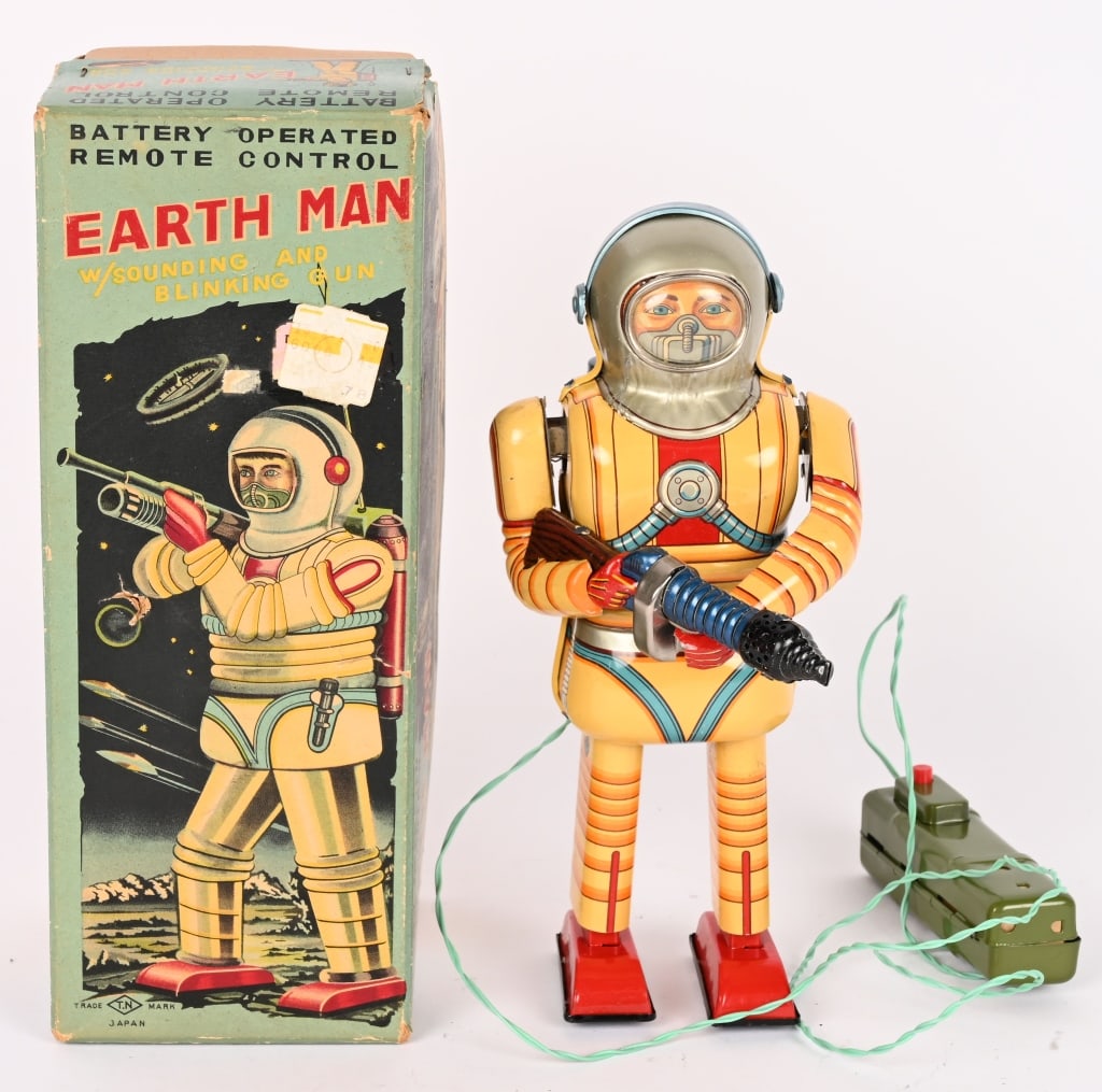 NOMURA BATTERY OP EARTH MAN ROBOT w/ BOX: Japan battery operated Earth Man Robot. Still has his gun. Great colors. Remote battery box is clean. Did work when tested. A very nice example. Comes with a box with Inserts. 9 1/2" Excellent