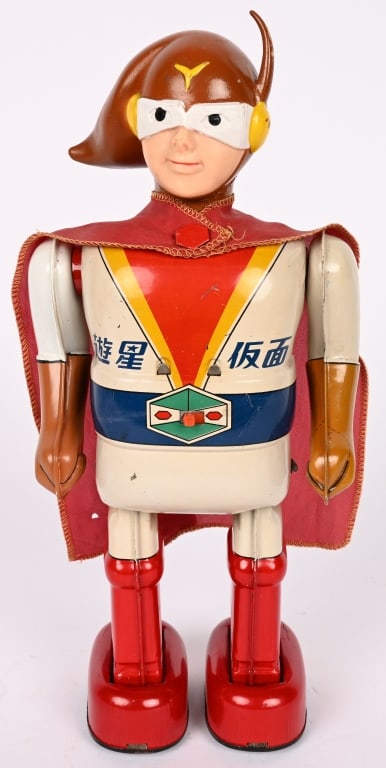 NOMURA BATTERY OP YUSEI KAMEN: Japan battery operated Yusei Kamen. All original and complete with cape. Very clean condition. Nice clean battery boxes. Worked when tested. A very scarce Japanese Superhero. 12" Excellent