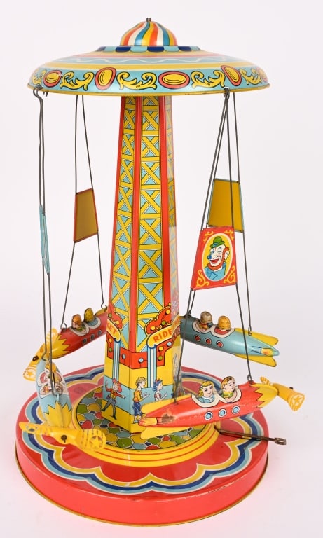 CHEIN TIN WINDUP ROCKET RIDE: Chein tin windup Rocket Ride. All original with great colors and graphics. Still has celluloid propellers. Windup works. Nice toy. 18" Excellent
