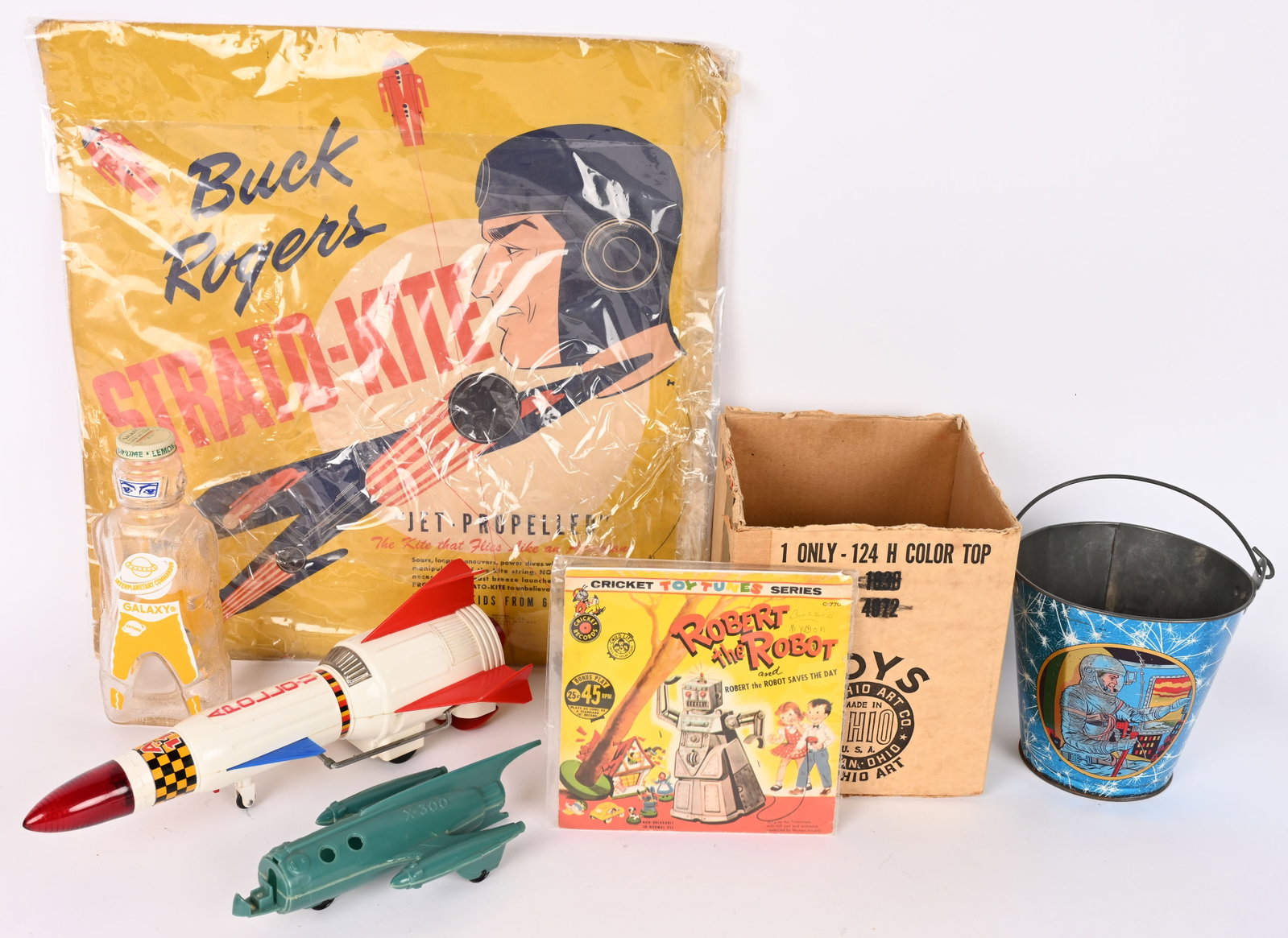LOT OF SPACE TOYS: Includes Buck Rogers Kite in Package, Astronaut Sand Pail in Box, Japan Apollo Rocket, Galaxy Bottle, and More. AS-IS
