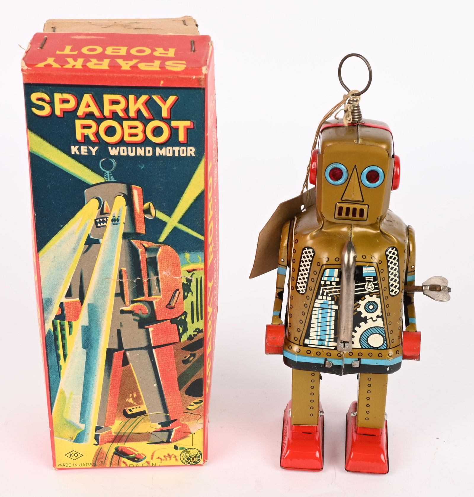 YOSHIYA TIN WINDUP LITHO SPARKY ROBOT w/ BOX: Japan tin windup Gold Litho Sparky Robot. All original and looks never played with condition. Still has instructions tag. Worked when tested. Boxed 7 1/2" Excellent