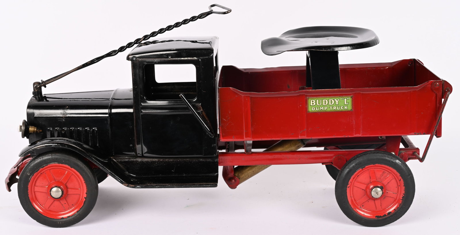 BUDDY L 1933-34 RIDE-ON HYDRAULIC DUMP TRUCK: Scarce 1933-34 Buddy L pressed steel Ride-On Hydraulic Dump Truck. All original with shiny paint and nice decals. Complete with seat and handle. Hard to find version with Electric Headlights. A great 