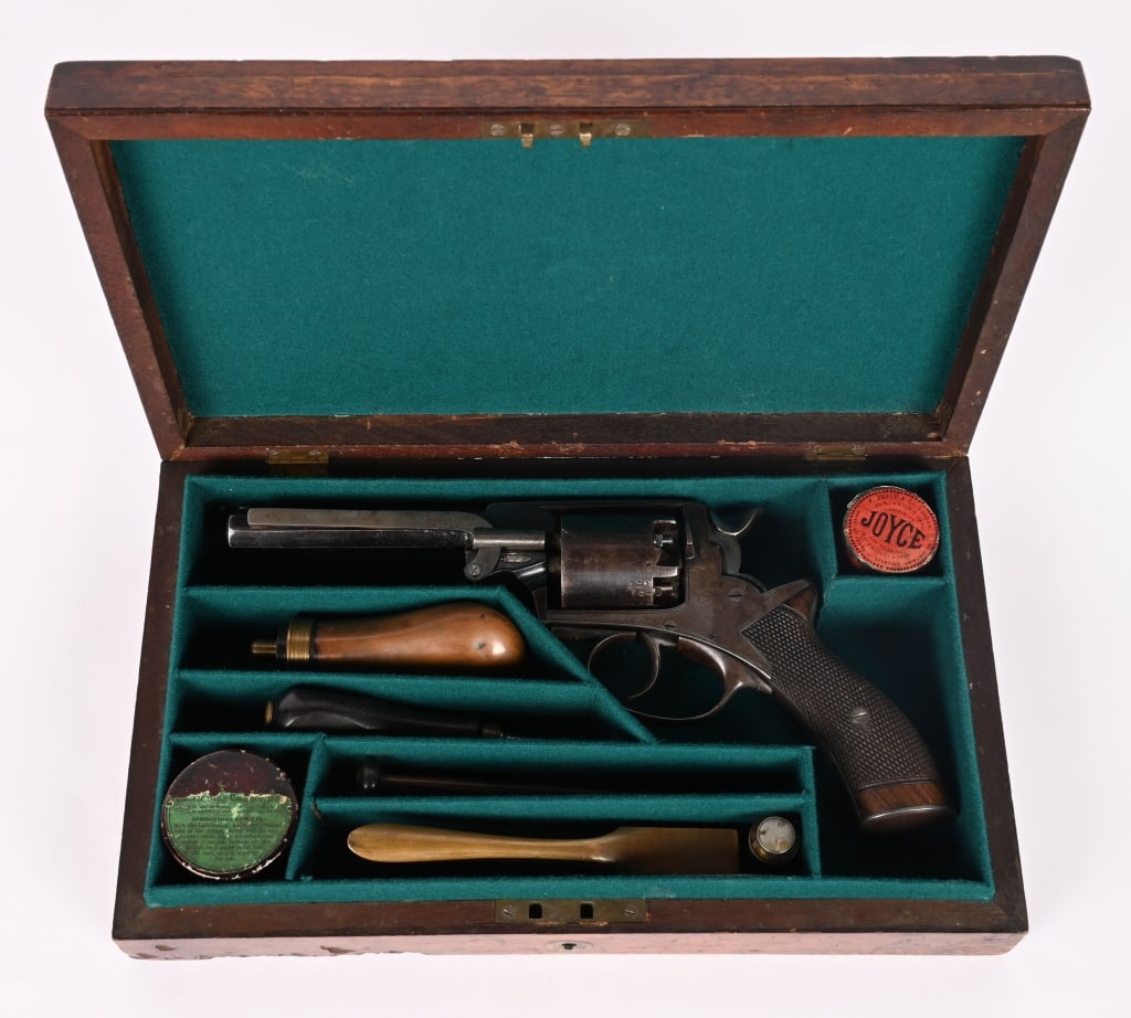 CASED BEAUMONT - ADAMS 1865 OPEN FRAME REVOLVER: SERIAL NUMBER: N.S.N. BARREL: 5 1/2" CALIBER: 54 GA. / .442 CAL. MANUFACTURED: 1860's A rare early open top frame model. Revolver is fully functional condition. This model retains the flanges to the r