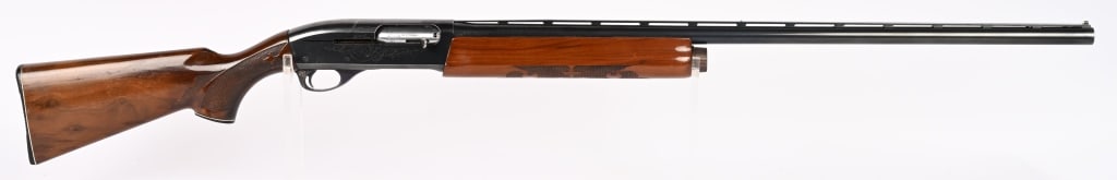 REMINGTON MODEL 1100 SEMI AUTO SHOTGUN: SERIAL NUMBER: L850479V. BARREL: 28". GAUGE 12. CHOKE MOD. CHAMBER 2 3/4". LOP 14". Features vent rib, blue finish, press checkered walnut stocks with pistol grip cap & monogram plate. Condition. 95% 