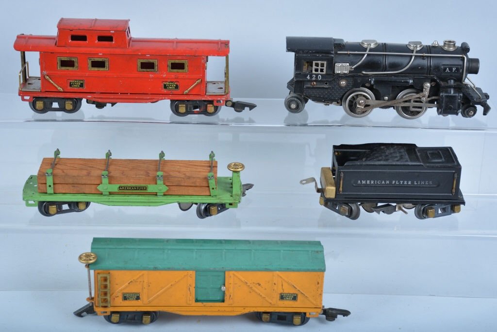 AMERICAN FLYER PRE WAR TRAIN SET: Includes 420 Engine and Tender, Box Car, Lumber Car, and Caboose. Some minor wear. Very Good