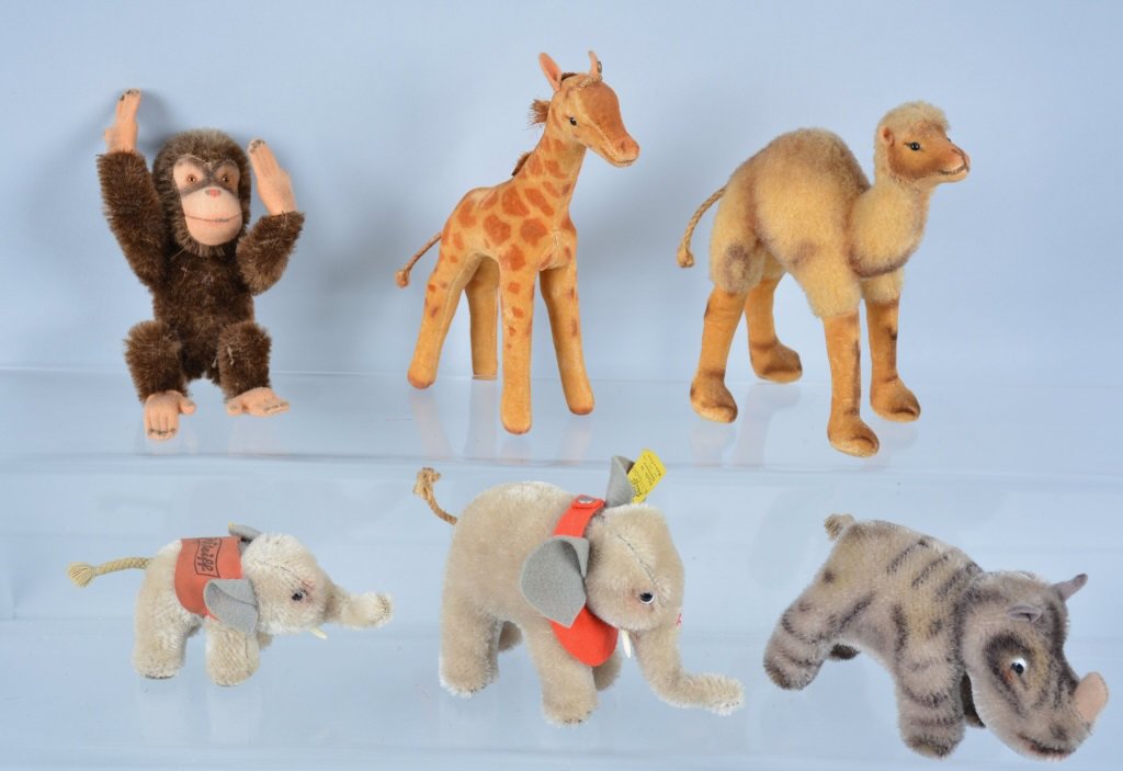 Lot of 6 STEIFF MINI ANIMALS: Includes Camal, Giraff, Nosy, Monkey, and 2 Elephants. Some with Tags and Buttons. Largest 6" Tall. Excellent-Near Mint