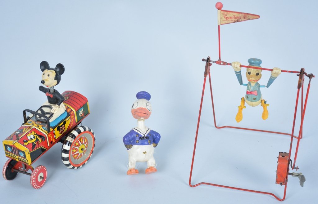 Lot of 3 Vintage Disney Toys: Linemar windup Donald Duck, is good and works well. Marx Mickey Mouse craxy car is excellent and works well, but arm is broken, 1930's long billed Donald Duck celluloid figure is 4 1/2" is fair with d