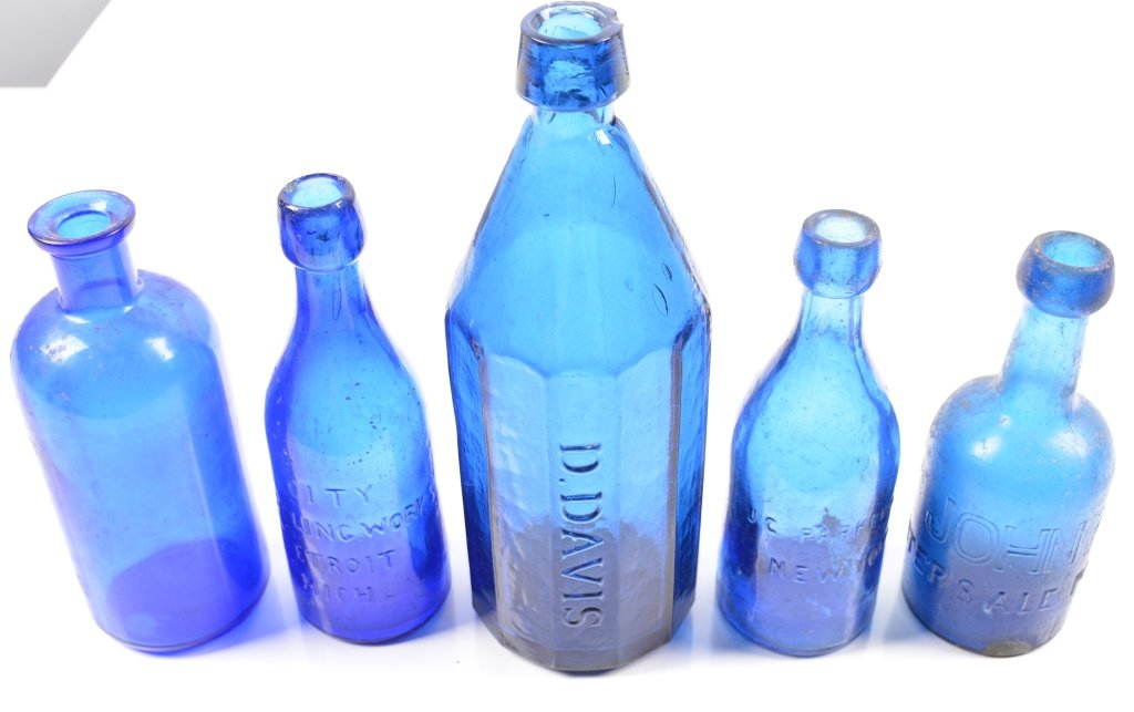 5-Cobalt Blue Spring Water Bottles: 19th century blue bottles by various makers. Ohio, Michigan,New York and Pennsylvania. 10". - Large bottle has small chip at lip, -Very Good-excellent