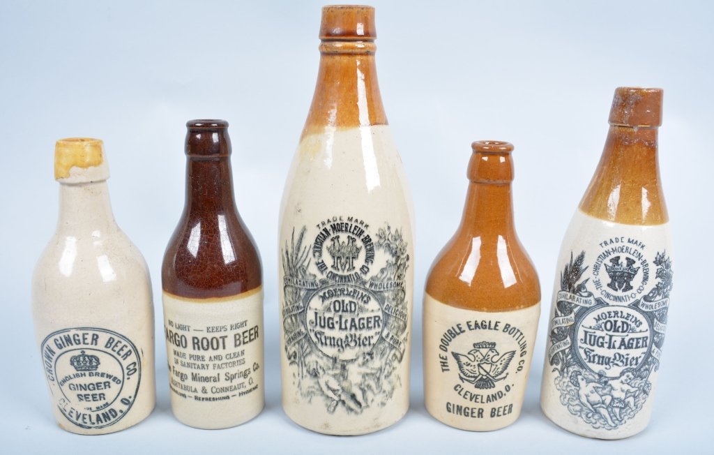 5-Ohio Ginger Beer Bottles: Double Eagle, Crown, 2-Moerlein's and Fargo, from Cleveland, Cincinnati, Ashtabula and Conneaut. 10 1/2", Crown bottle has repair at lip. Very Good-Excellent