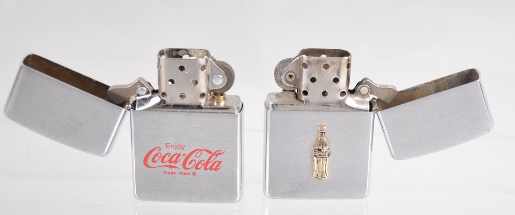 Lot of 2 Vintage Coca Cola Zippo Lighters: Nice lot of vintage Zippos. One with applied gold Coke bottle. Excellent