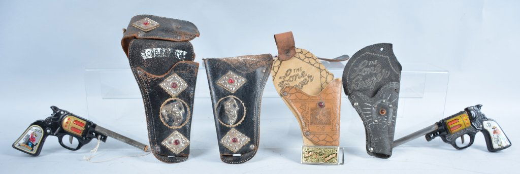 Vintage Lone Ranger Lot: 2-Single holsters, double holster de-tached, belt buckle, and 2-tin generic pop guns, one does not work, guns are 9", -Good-Very Good